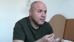 Middle aged man taking pill and drinking water from glass, sitting on bed in bedroom - Powered by Shutterstock - Get 15% off with code: PIKWIZARD15