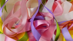 Satin multi-colored ribbons rotate on display case. Sewing accessories theme, craft, design, fashion, handmade. - Powered by Shutterstock - Get 15% off with code: PIKWIZARD15