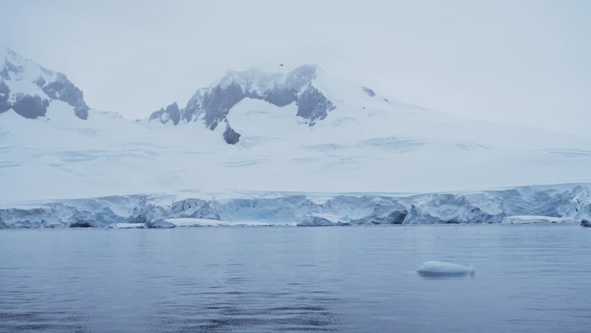 Winter Mountains and Glacier on Coast, Coastal Mountain Scenery in Antarctica, Cold Blue Landscape and Seascape with Glacier Ice and Ocean Sea Water, Antarctic Peninsula Dramatic Coastline Scene