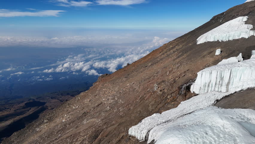 Drone footage of the Uhura Peak on Mount Kilimanjaro in Africa, cinematic rotating aerial footage,