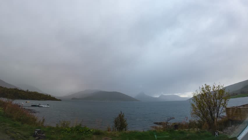 Dramatic timelapse of moving clouds over norwegian fjord
