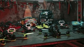 A small fleet of FPV drones neatly displayed on a table, captured with cinematic lighting and angles, perfect for showcasing technology or drone-related content. - Powered by Shutterstock - Get 15% off with code: PIKWIZARD15