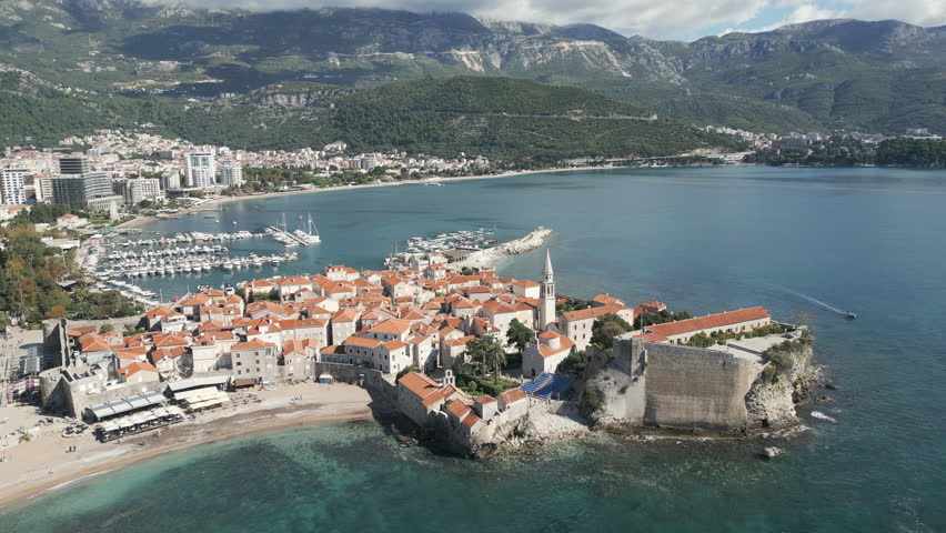 Aerial perspective of Old town Budva, a medieval fortification located on the Adriatic coast in Budva, Montenegro. Flying forwards.