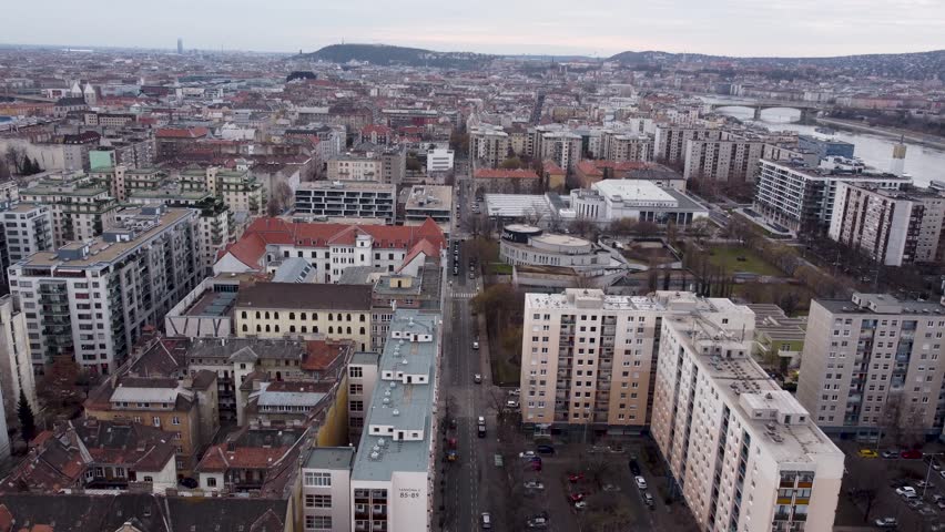 Budapest , Central Hungary , Hungary - 11 17 2024: Aerial view of Budapest cityscape with sprawling apartment buildings, tree-lined streets, and a balanced horizon, Budapest, Hungary, November 2024