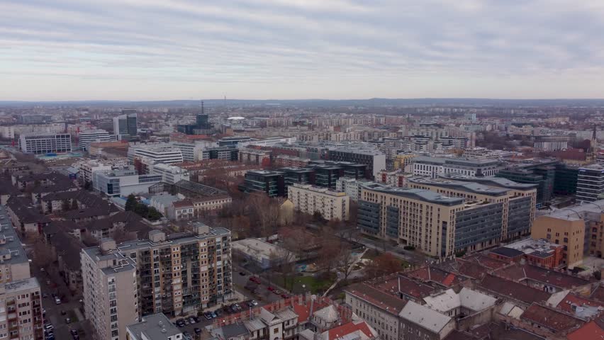 Budapest , Central Hungary , Hungary - 11 17 2024: Aerial orbital of Budapest’s urban stretch, showcasing a mix of red-roofed and gray buildings, Hungary, November 2024