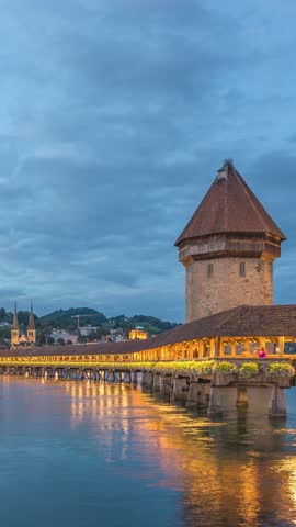 Lucerne (Luzern) Switzerland time lapse day to night city skyline at Chapel Bridge (Vertical)