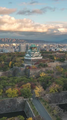 Osaka Japan time lapse city skyline day to night at Osaka Castle in autumn season