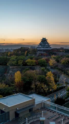 Osaka Japan time lapse city skyline sunrise at Osaka Castle in autumn season (vertical)