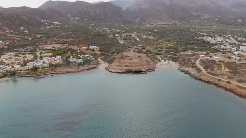 Coastal view of Crete island with two mini beaches and mountain backdrop