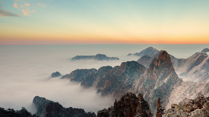Time lapse looking out over a sea of fog at the Yellow Mountains (Huangshan) in China at sunset