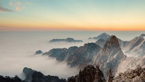 Time lapse looking out over a sea of fog at the Yellow Mountains (Huangshan) in China at sunset - Powered by Shutterstock - Get 15% off with code: PIKWIZARD15