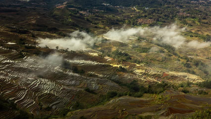 Time lapse looking down at the hundreds of layers of terraced rice fields in Yuanyang China.
