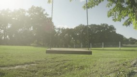 Empty wooden tree swing during sunny afternoon. - Powered by Shutterstock - Get 15% off with code: PIKWIZARD15