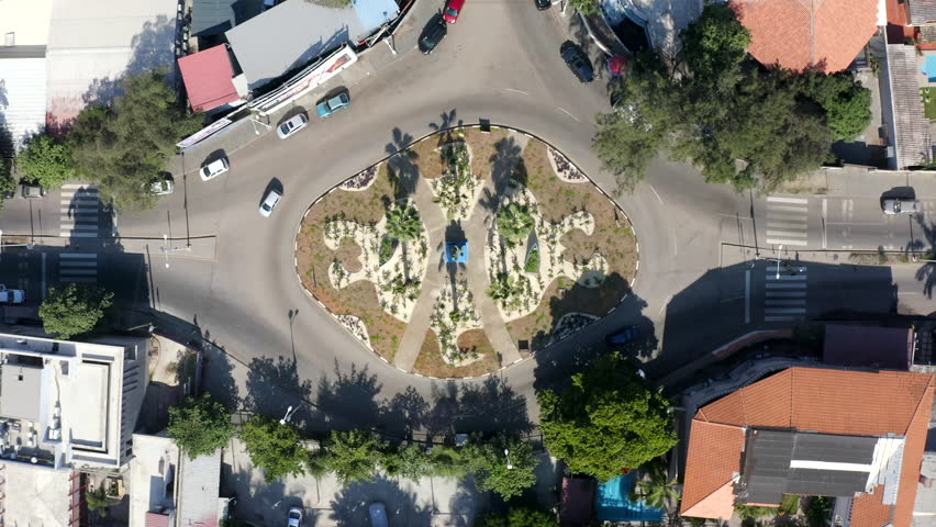 Drive Over Roundabout Road In Luanda City, Angola Africa. Aerial Ascending Shot