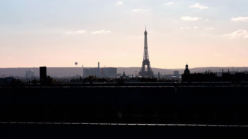 Romantic and beautiful view of rooftops and Eiffel Tower with the sunset sky in Paris, France. 