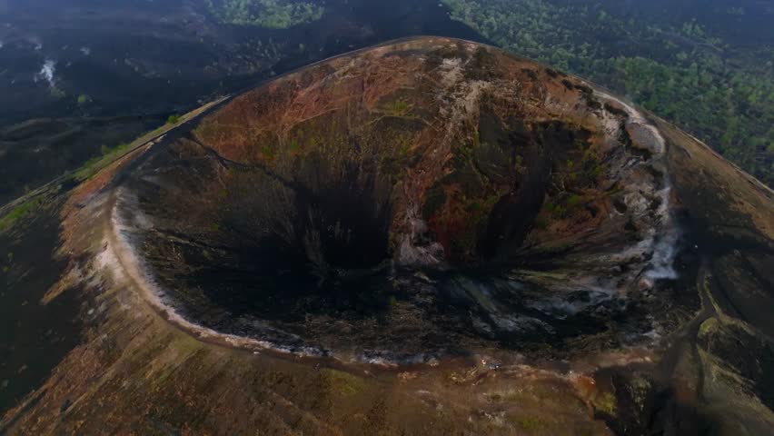 Approaching shot over Paricutin Volcanic crater reveals volcanic cone with cooled lava fields. Top down drone aerial