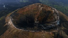 Approaching shot over Paricutin Volcanic crater reveals volcanic cone with cooled lava fields. Top down drone aerial - Powered by Shutterstock - Get 15% off with code: PIKWIZARD15