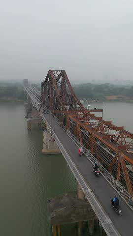 Aerial view of traffic on historic Long Bien Bridge and Hanoi city skyline in Vietnam
