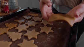 Close-up of gingerbread cookies on oven tray before baking. Slow motion. Spruces and stars as symbol of Christmas. Heart shape made of dough. Gingerbread make edible gift for family and friends - Powered by Shutterstock - Get 15% off with code: PIKWIZARD15