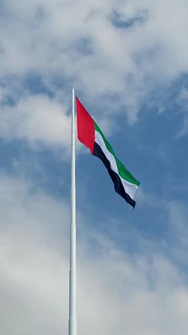 UAE flag waving in the blue sky, national symbol of UAE. High quality 4k footage.
