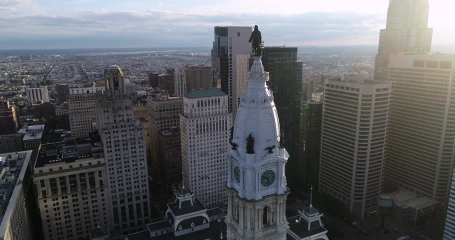Statue of William Penn on Philadelphia City Hall Tower. Beautiful Cityscape. Business District and Downtown. Morning Sunlight. 4k