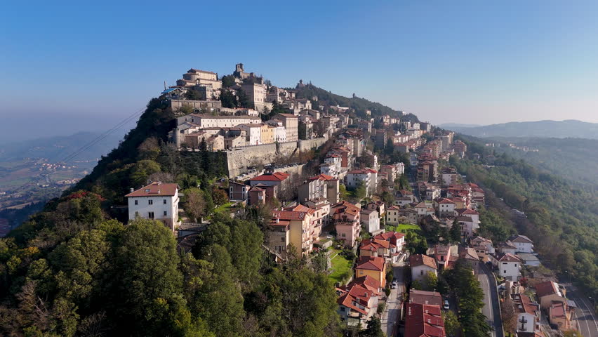 Scenic drone view of the medieval Guaita Tower surrounded by rolling hills in San Marino.