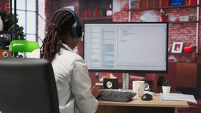 Cheerful software developer at computer waiting for code to finish compiling, celebrating after managing to make it run without errors. Woman happy after finishing work on algorithm scripts, camera B - Powered by Shutterstock - Get 15% off with code: PIKWIZARD15