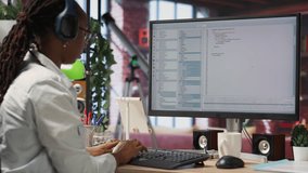 Jolly engineer in home office working on computer, dancing at desk in celebration after successfully executing code. IT worker wearing headphones happy after finishing compiling code, camera B - Powered by Shutterstock - Get 15% off with code: PIKWIZARD15