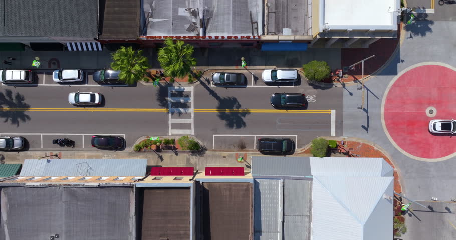 Main street intersection with slow traffic and old historical architecture in small town America. Southern low buildings in Starke, Florida.