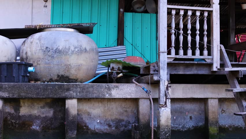 Wooden house and trees by a canal