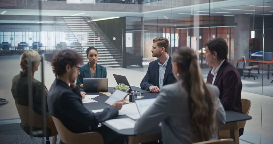 Company Executives Sharing Ideas and Debating Strategies in a Meeting Room. Male and Female Colleagues Discuss Market Trends, Analyze Competitive Landscapes and Develop Innovative Business Plans