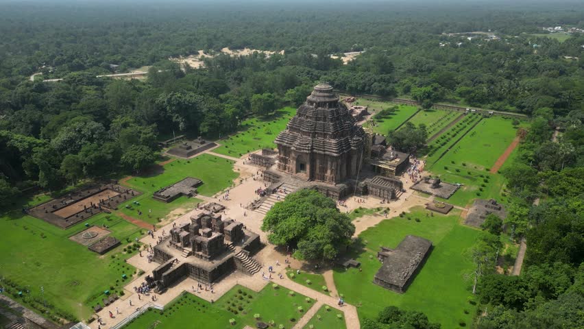 Stunning aerial shot of the Konark Sun Temple in Odisha, an architectural marvel and UNESCO World Heritage Site, surrounded by lush greenery and showcasing its intricate design.