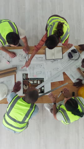 Architecture, handshake and above of people with blueprint for design, floorplan and building. Civil engineering, collaboration and contractor team shaking hands for agreement, meeting and discussion