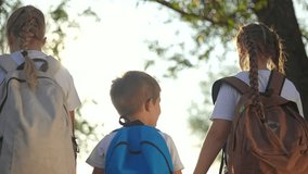Children walk nature with backpack. Sunlight shining as Children hold hands enjoying outdoor adventure. explorers bonding during scenic hike. Backpack symbol adventure. Happy children nature together. - Powered by Shutterstock - Get 15% off with code: PIKWIZARD15