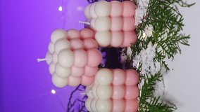 vertical video. Cute white and pink Bubble candles on purple background. items for New Year's interior decor. - Powered by Shutterstock - Get 15% off with code: PIKWIZARD15