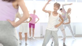 Group of boys and girls with teacher doing warm-up exercises before dancing in studio - Powered by Shutterstock - Get 15% off with code: PIKWIZARD15