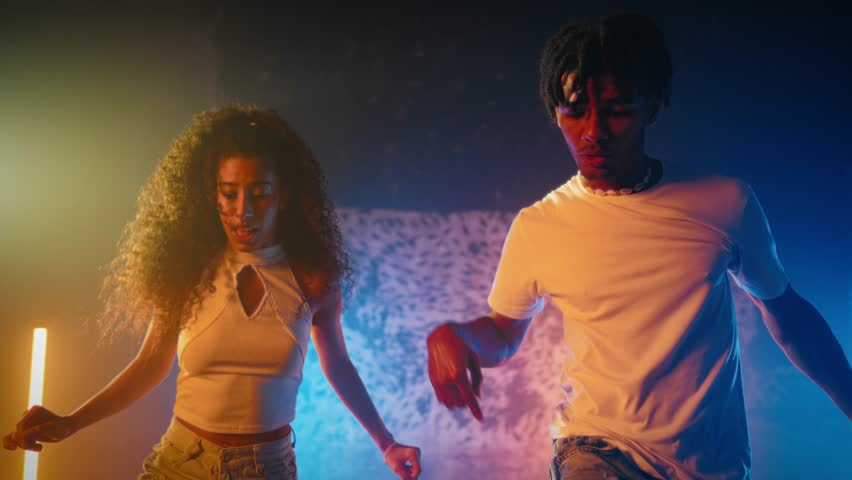 Young black male and female dancers expressing emotions and feelings by dance. Enjoy music and dance, African American people performing traditional and contemporary choreography, slow motion shot