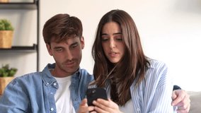 Millennial couple annoyed by stuck cellphone or online news sitting together on sofa, frustrated young angry customers confused by phone problem feeling perplexed or puzzled about email message
 - Powered by Shutterstock - Get 15% off with code: PIKWIZARD15