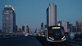 night scene of a train swiftly moving through a modern urban environment with skyscrapers, showcasing illuminated buildings and busy city life. Captures the essence of metropolitan transportation afte - Powered by Shutterstock - Get 15% off with code: PIKWIZARD15
