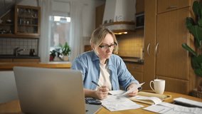 Female calculating family budget financial and accounting at home, young woman working with financial data calculator with tablet computer and writing make note calculate, pay bills tax online - Powered by Shutterstock - Get 15% off with code: PIKWIZARD15