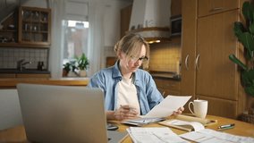 Female calculating family budget financial and accounting at home, young woman working with financial data calculator with tablet computer and writing make note calculate, pay bills tax online - Powered by Shutterstock - Get 15% off with code: PIKWIZARD15