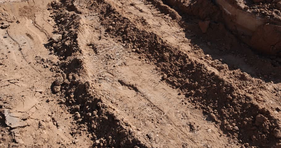 a pit before asphalting road close up, a deep hole in the ground on the site of which a road was started