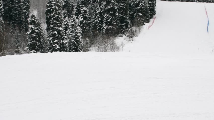 Close up young advanced professional boy skier and snowboarder friends have fun jump in slow motion ski downhill in Mestia hatsvali ski resort outdoors on fresh snow day enjoy active winter holidays
