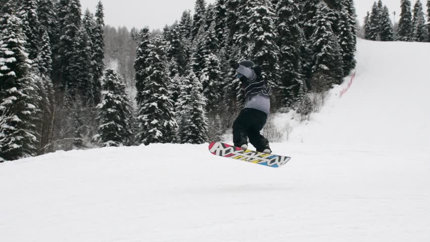 Close up young advanced professional boy skier and snowboarder friends have fun jump in slow motion ski downhill in Mestia hatsvali ski resort outdoors on fresh snow day enjoy active winter holidays
