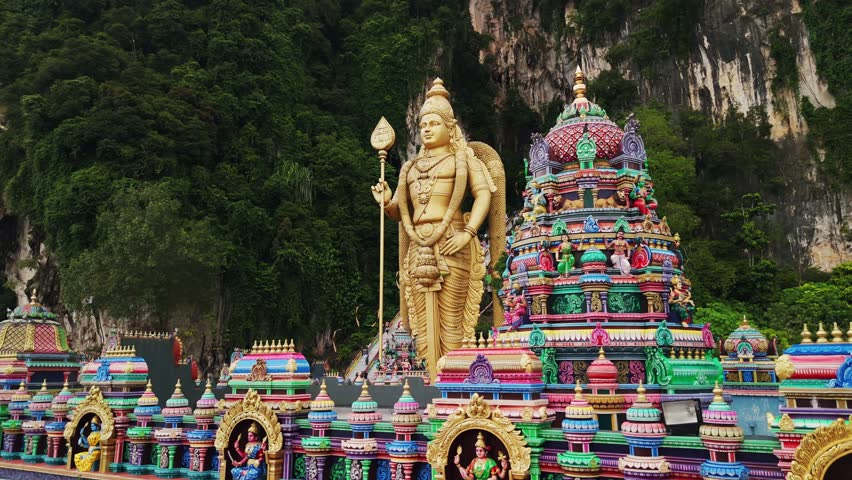Batu caves temple with the giant golden statue of the hindu god murugan in gombak district, selangor, malaysia