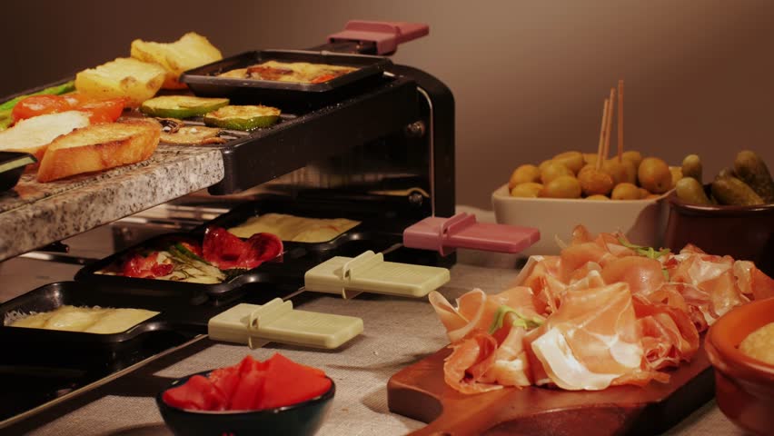 French Swiss or Spanish restaurant with traditional tapas food, Spanish cuisine, delicious tapas and cheese plate, bruschetta with cheese, olives dry tomatoes and tasty sandwich bar appetizer, buffet