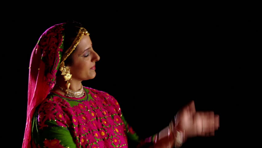 Attractive Indian girl in traditional dance costume makes gestures with her