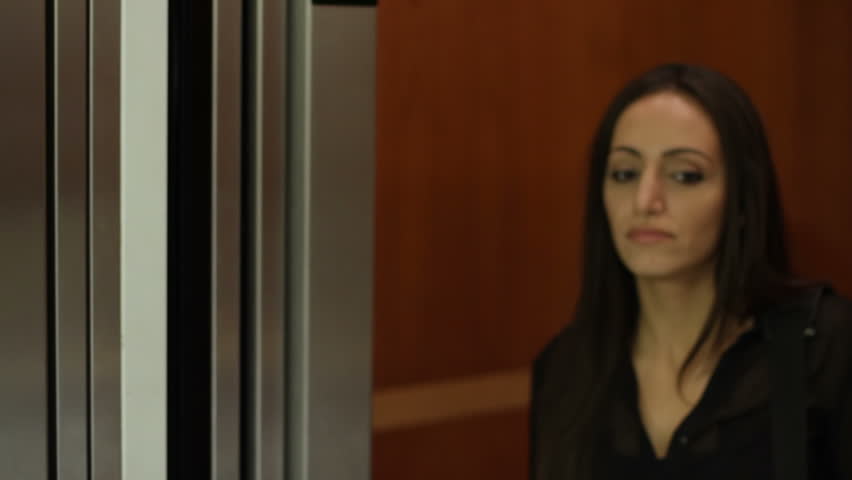 Businessman arrives too late to catch an elevator as doors close on woman