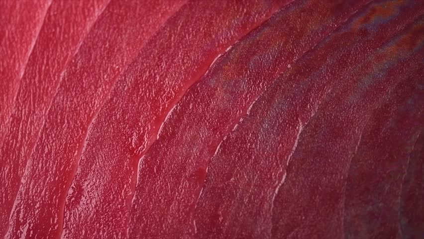 Tuna texture background, steak. Fresh raw tuna fish fillet close-up, sea fish rotating backdrop, top view, flat lay. Fresh sliced bluefin tuna raw meat texture macro shot