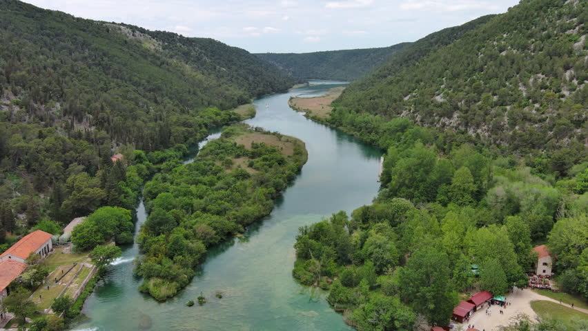 Aerial high view of beautiful Krka National Park, green foliage and turquoise water, Croatia, 4k